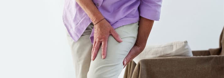 Woman-Holding-Leg Woman Holding Leg in Pain